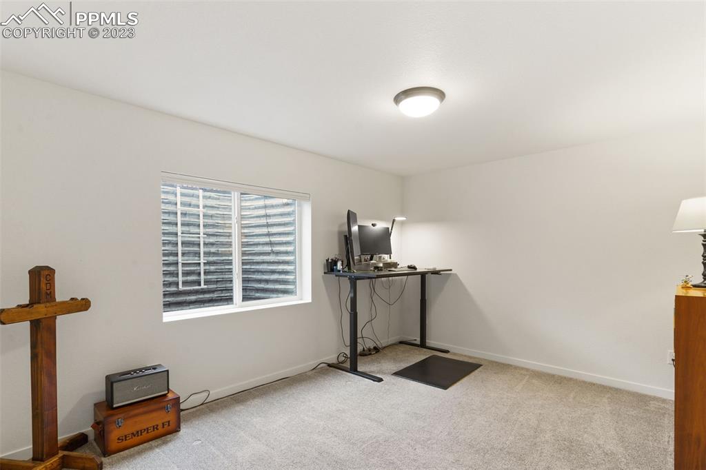 11969 Alydar Loop Colorado Springs, CO 80921 - Photo 28 of 39 a room with gym equipment and a window