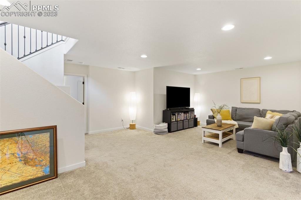 11969 Alydar Loop Colorado Springs, CO 80921 - Photo 32 of 39 a living room with furniture and a flat screen tv