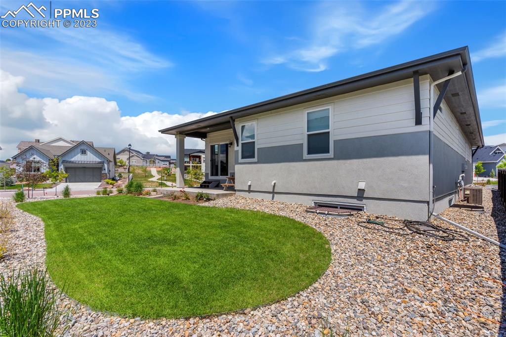 11969 Alydar Loop Colorado Springs, CO 80921 - Photo 37 of 39 a backyard of a house with table and chairs