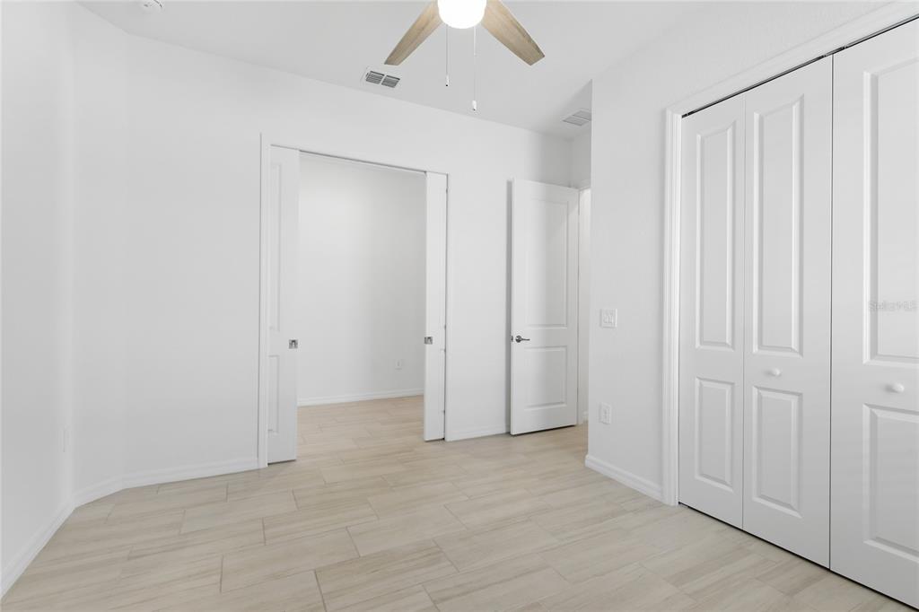 19156 Cherrystone Way Lakewood Ranch, FL 34211 - Photo 16 of 49 an empty room with a ceiling fan and a window