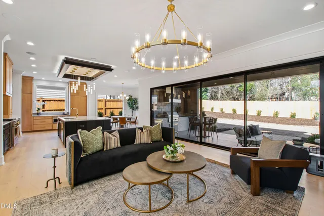 a kitchen with stainless steel appliances a stove a sink dishwasher and a refrigerator with wooden floor