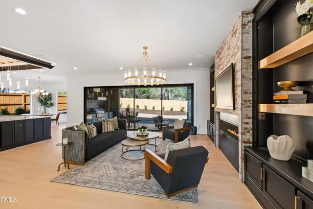 a dining room with furniture a rug and a chandelier