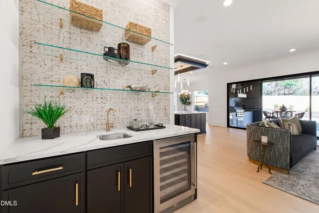 a spacious bedroom with a large bed and a chandelier