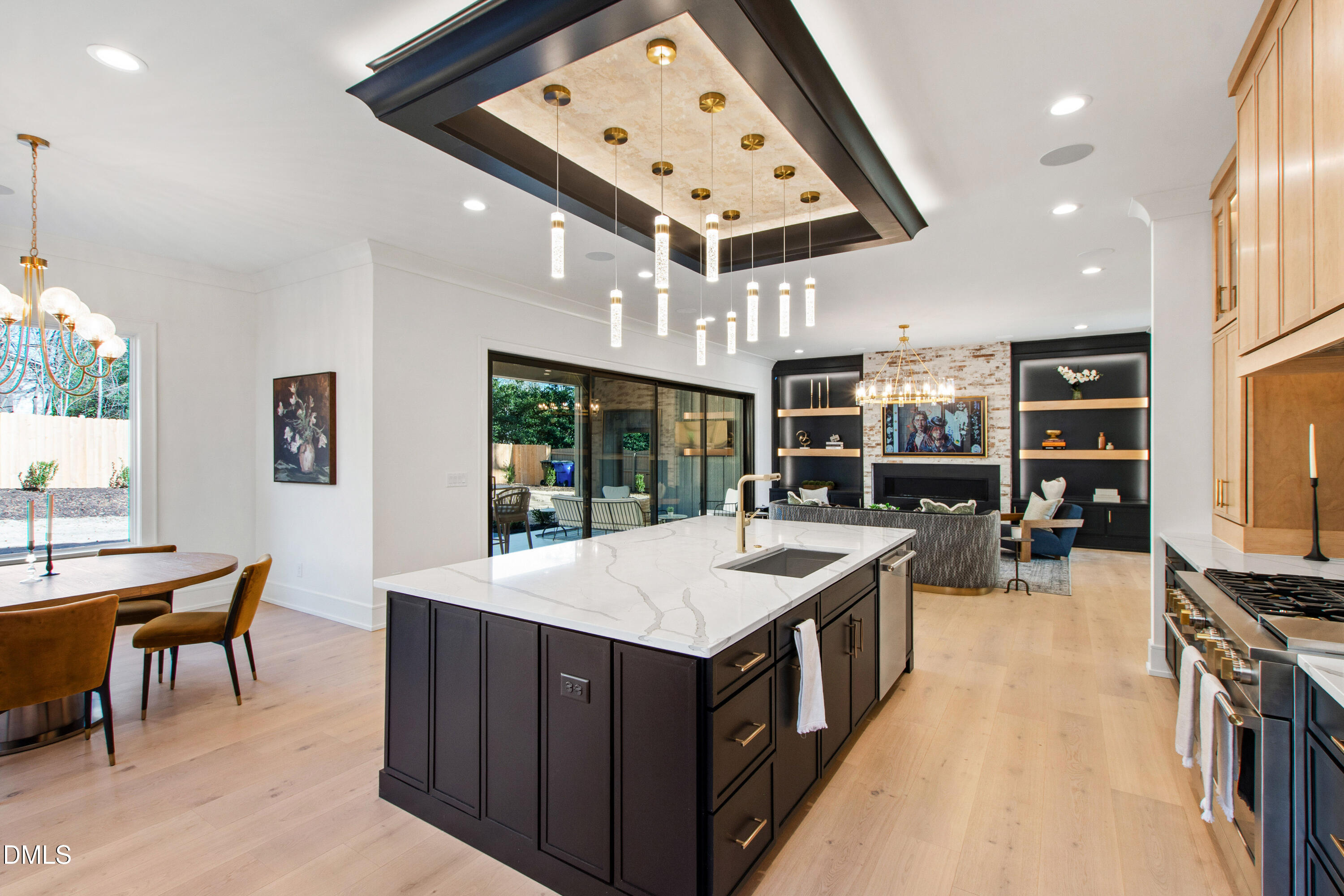 405 Latimer Road Raleigh, NC 27609 - Photo 22 of 100 a large kitchen with kitchen island a stove a sink a dining table and chairs