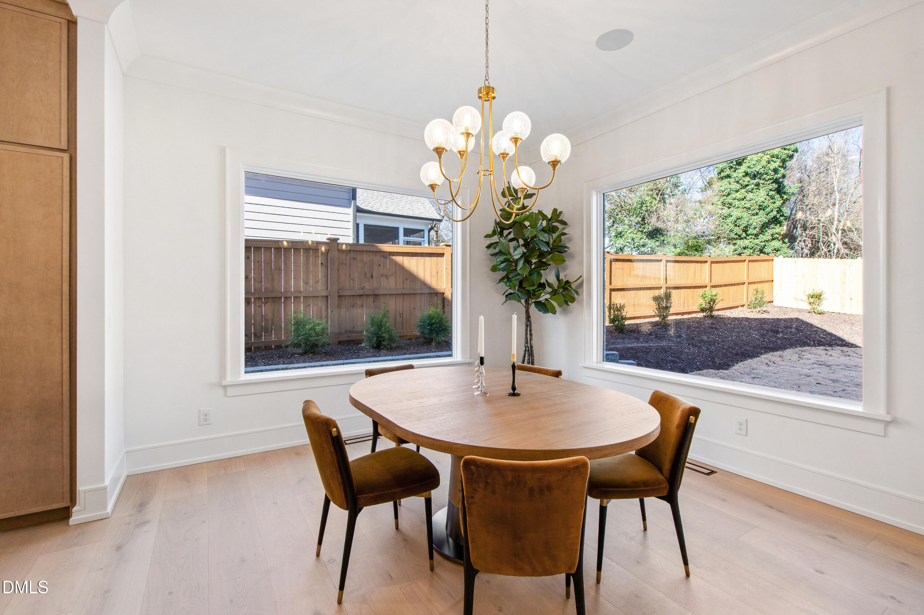 405 Latimer Road Raleigh, NC 27609 - Photo 27 of 100 a dining room with furniture a rug and a chandelier