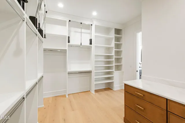 a view of walk in closet with empty racks