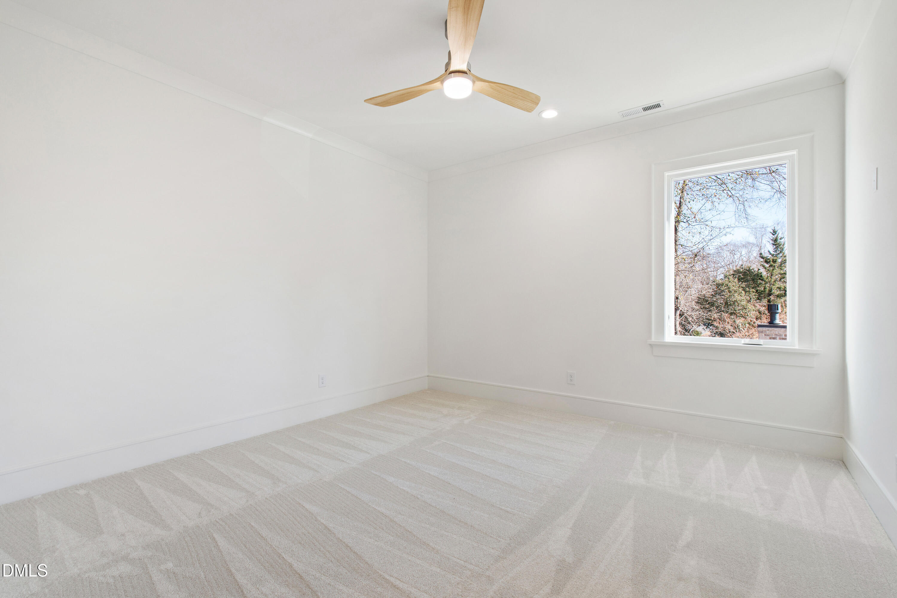 405 Latimer Road Raleigh, NC 27609 - Photo 62 of 100 an empty room with a window and a fan