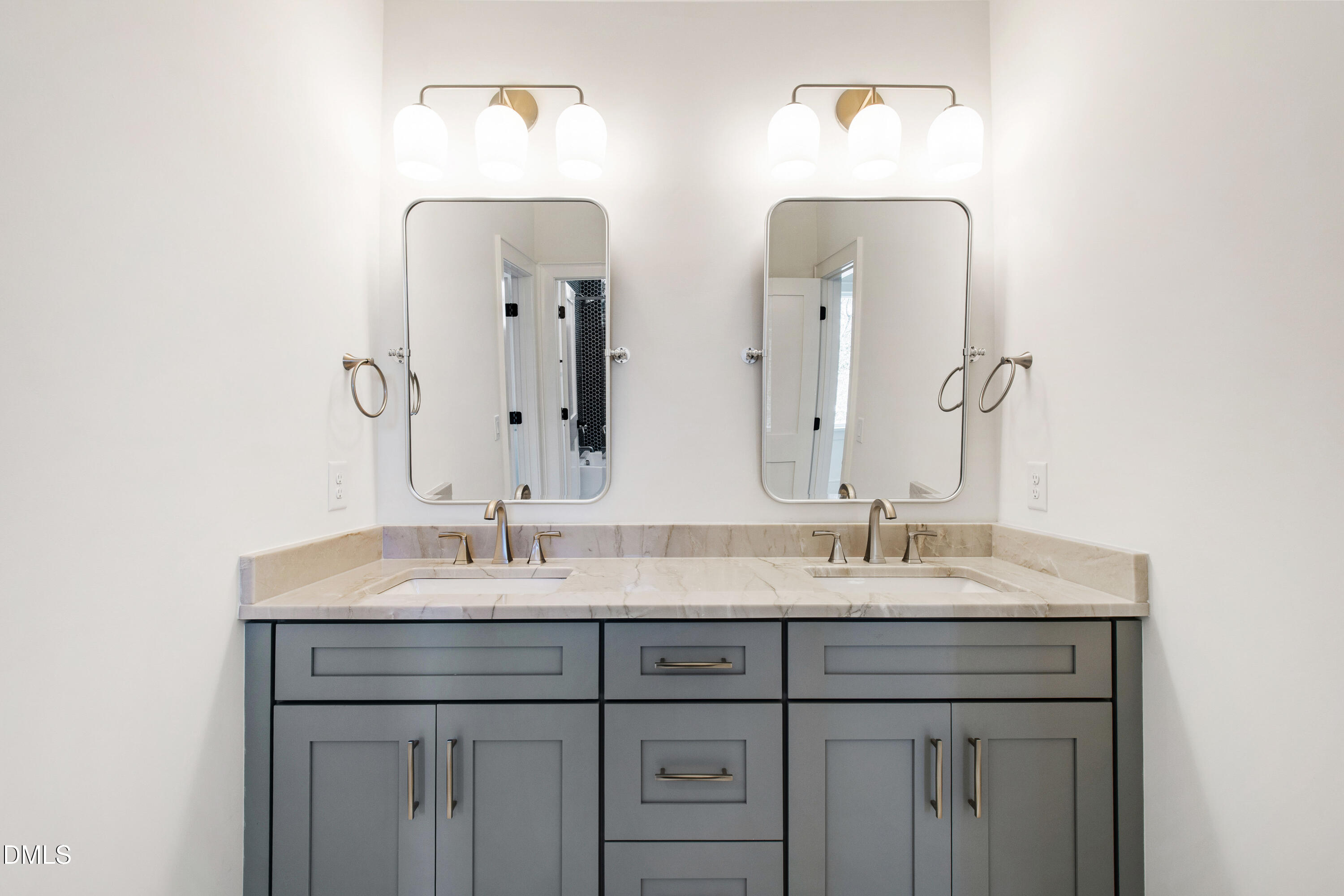405 Latimer Road Raleigh, NC 27609 - Photo 65 of 100 a bathroom with a double vanity sink and a mirror