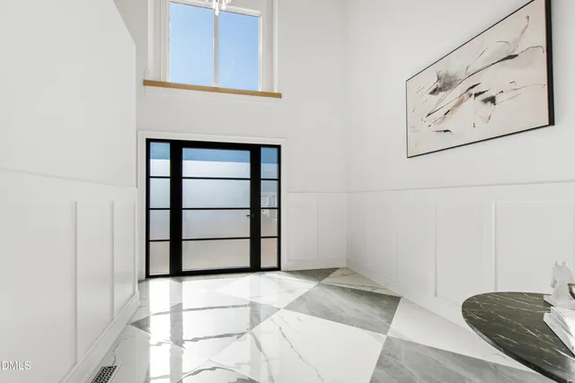 a dining room with furniture and a floor to ceiling window