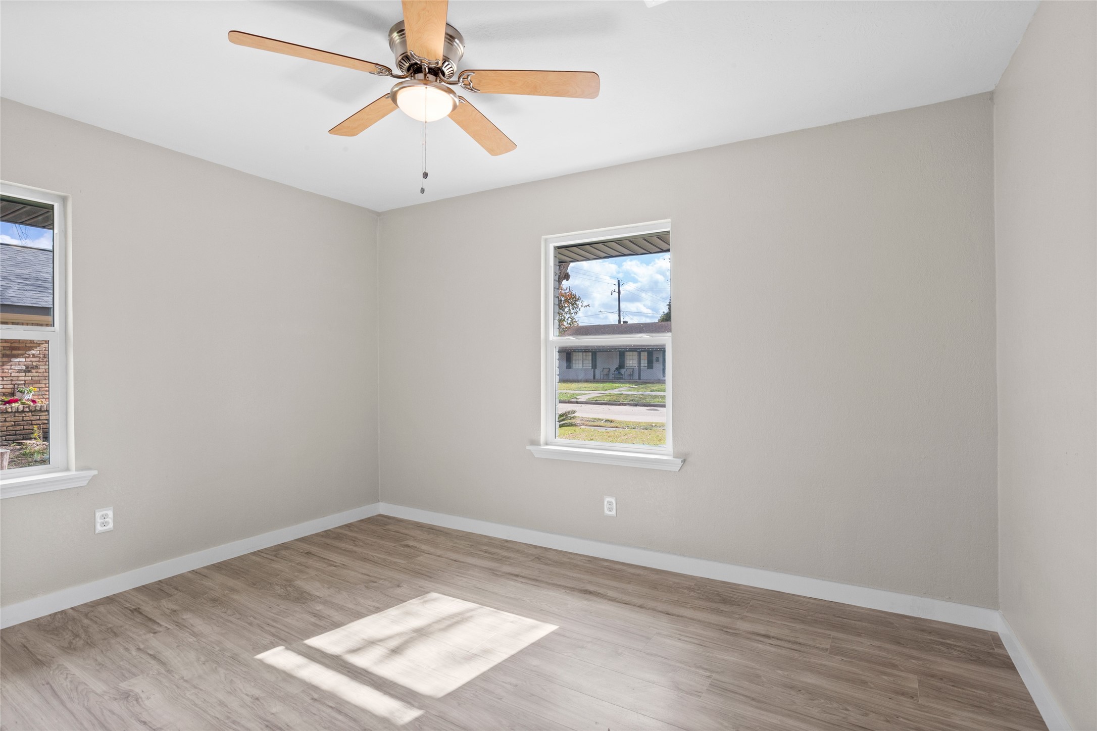 10127 Tolman Street Houston, TX 77034 - Photo 20 of 27 The room features wide-plank, wood-look flooring in a light oak or sand-colored finish.