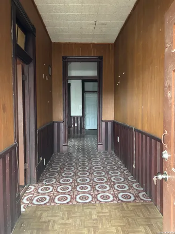 a view of a hallway with brick walls and dining room