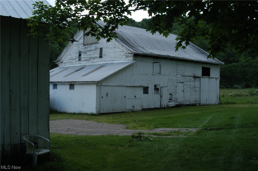 8957 Tinney Road Dennison, OH 44621 - Photo 14 of 26 View of side of property with a yard