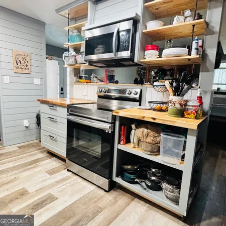 a kitchen with stainless steel appliances kitchen island a stove and a microwave