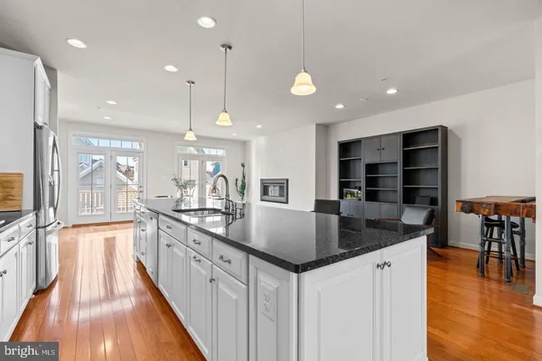 a kitchen with stainless steel appliances granite countertop a sink counter space and cabinets