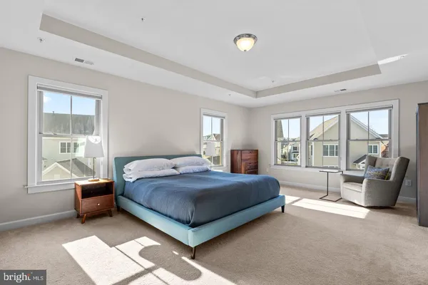 a bedroom with a bed and glass window