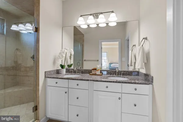 a bathroom with a double vanity sink and a mirror