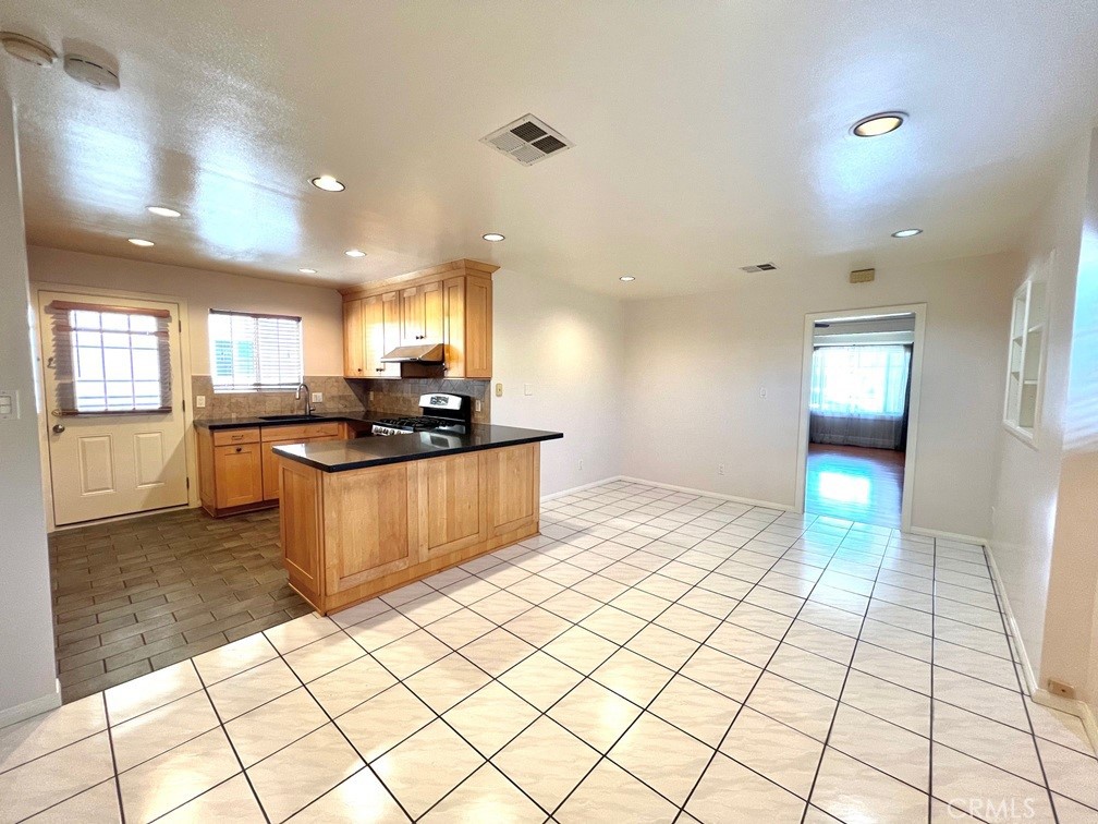 2909 Front Street Alhambra, CA 91803 - Photo 16 of 34 a kitchen with stainless steel appliances kitchen island granite countertop a sink and cabinets