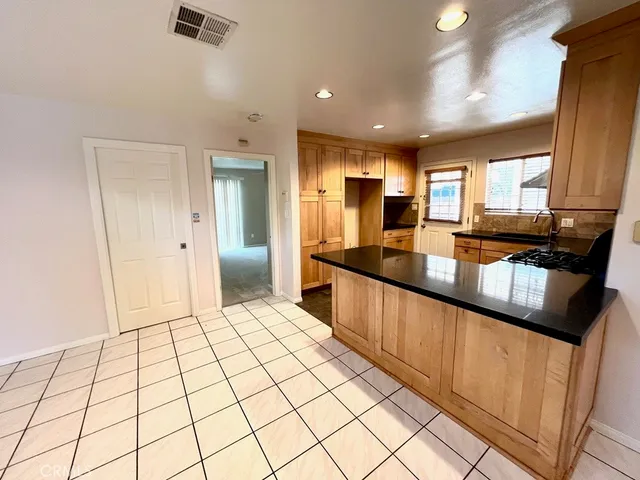 a kitchen with granite countertop a sink stove and refrigerator