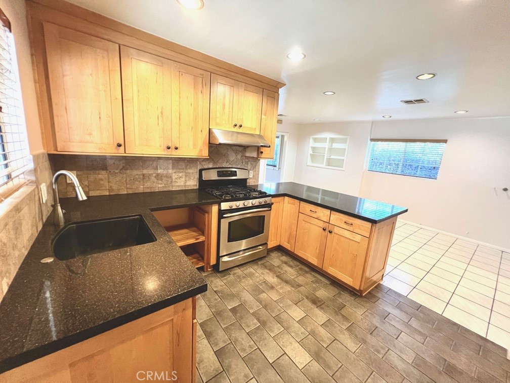 2909 Front Street Alhambra, CA 91803 - Photo 20 of 34 a kitchen with stainless steel appliances granite countertop a stove a sink and a microwave