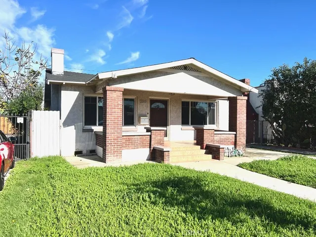 a front view of a house with porch and garden