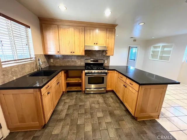 a kitchen with stainless steel appliances a refrigerator and a sink
