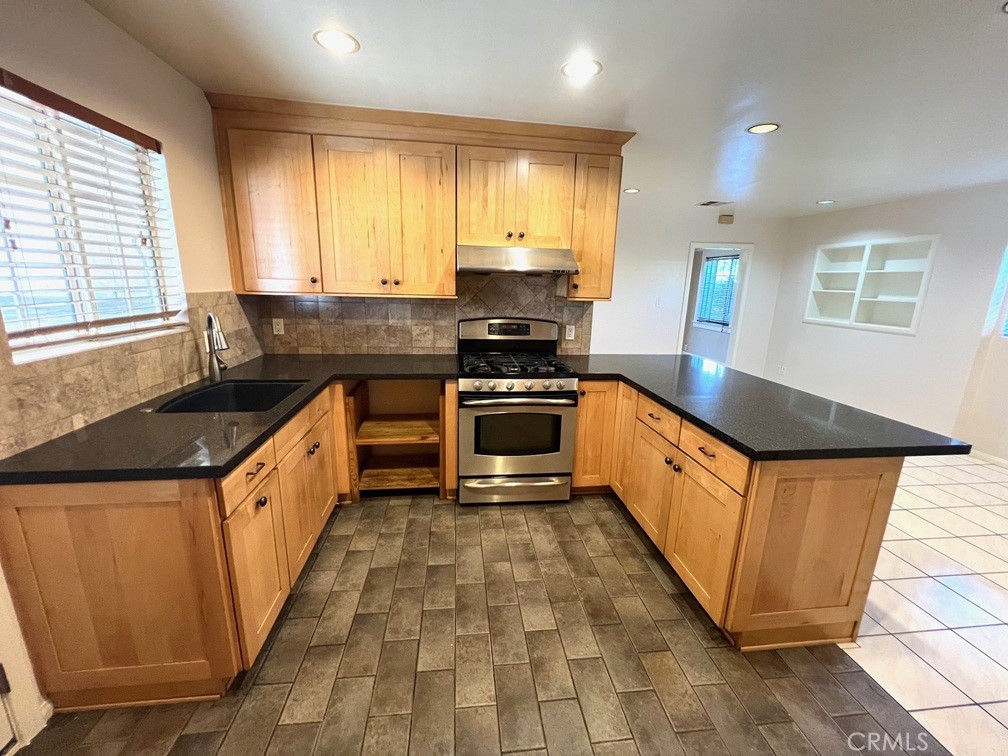 2909 Front Street Alhambra, CA 91803 - Photo 21 of 34 a kitchen with stainless steel appliances granite countertop a stove a sink and a microwave