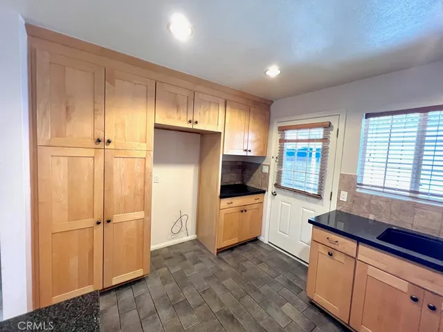 a kitchen with stainless steel appliances granite countertop a sink stove and cabinets