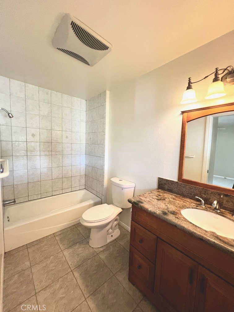 2909 Front Street Alhambra, CA 91803 - Photo 28 of 34 a bathroom with a granite countertop sink a toilet a mirror and bathtub