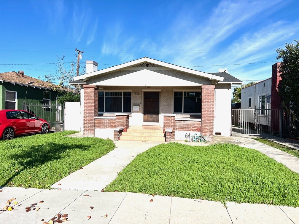 2909 Front Street Alhambra, CA 91803 - Photo 3 of 34 a front view of a house with a yard and potted plants