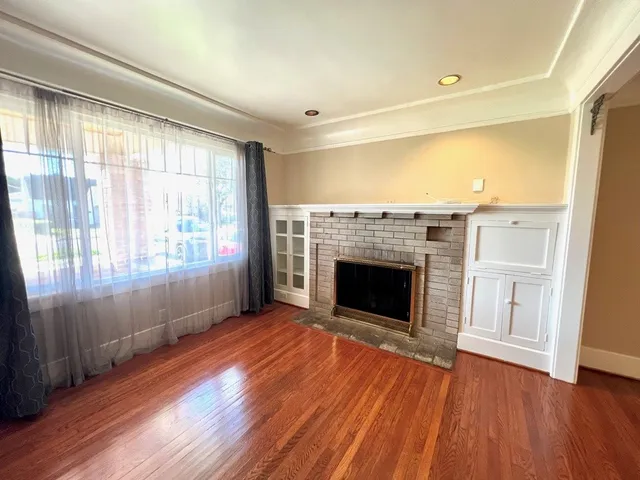 a view of a livingroom with a fireplace and window