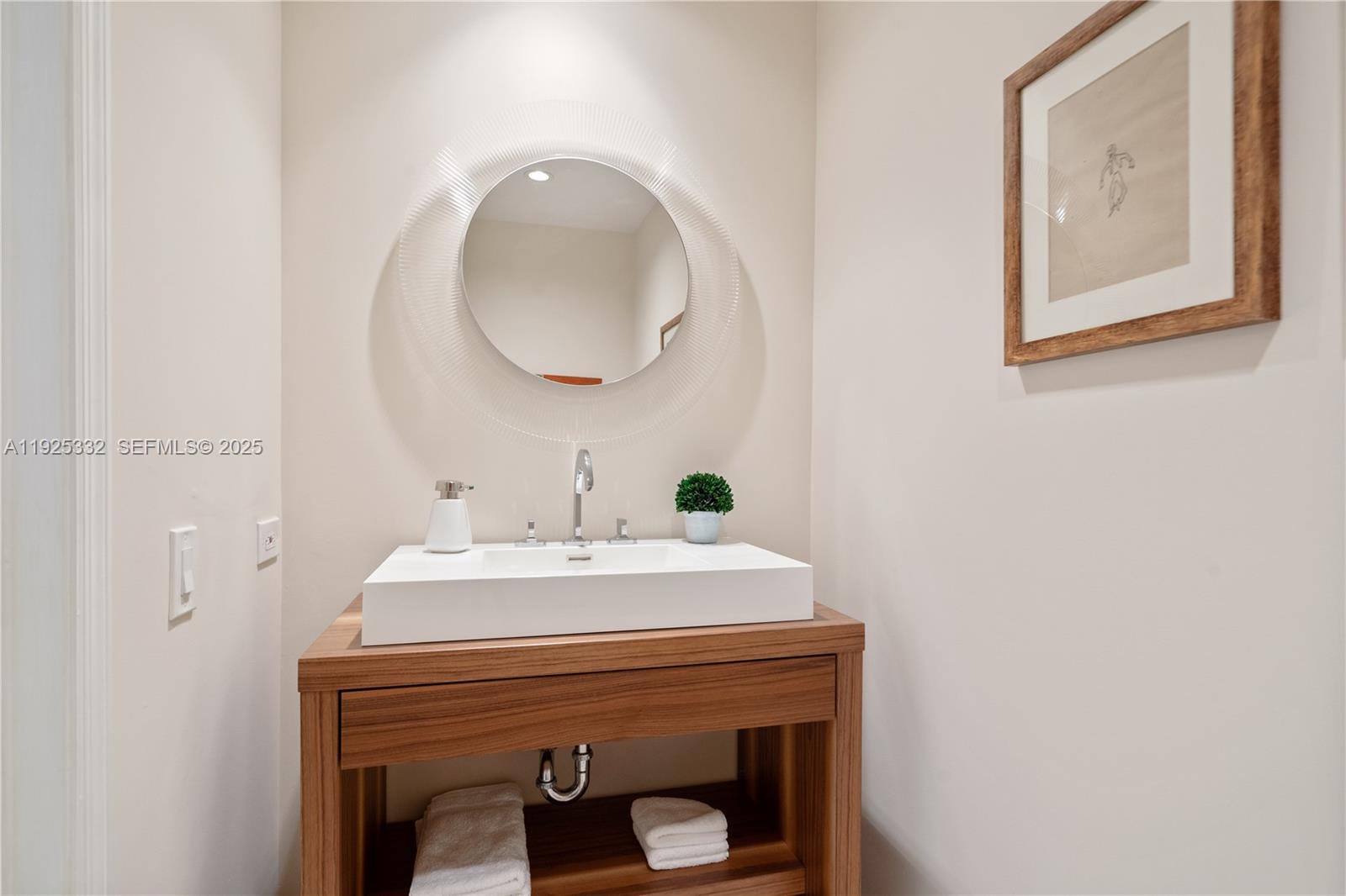 808 Brickell Key Drive, Unit 3304 Miami, FL 33131 - Photo 21 of 60 a bathroom with a sink and a mirror