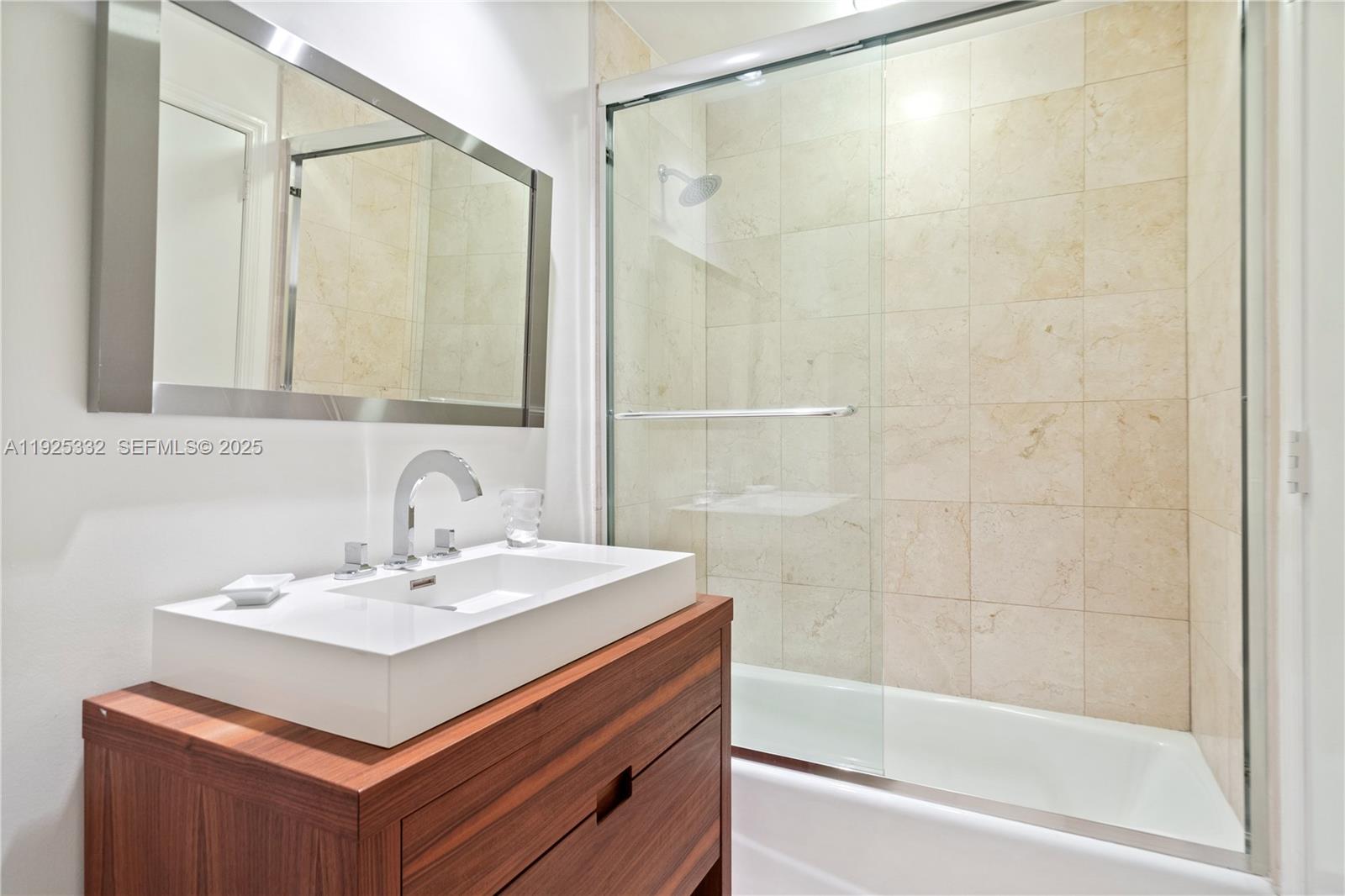 808 Brickell Key Drive, Unit 3304 Miami, FL 33131 - Photo 22 of 60 a bathroom with a sink mirror and a shower