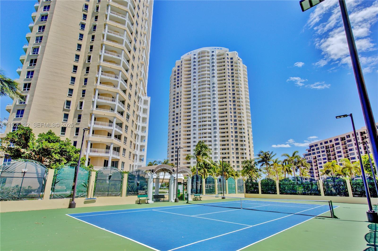 808 Brickell Key Drive, Unit 3304 Miami, FL 33131 - Photo 54 of 60 a view of a tall building next to a yard