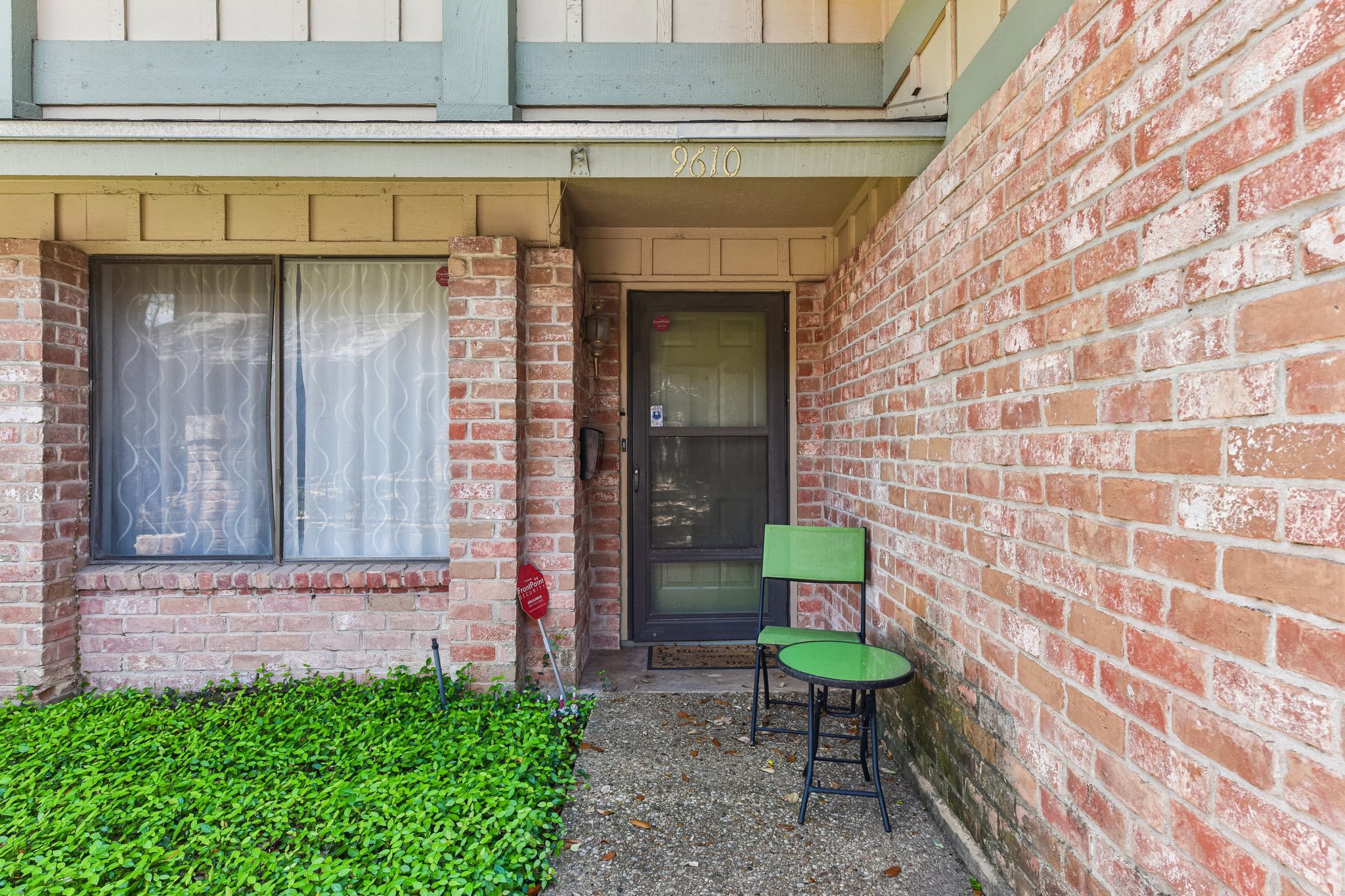 9610 Covey Ridge Lane Austin, TX 78758 - Photo 5 of 22 Brick facade with a covered entry and concrete walkway