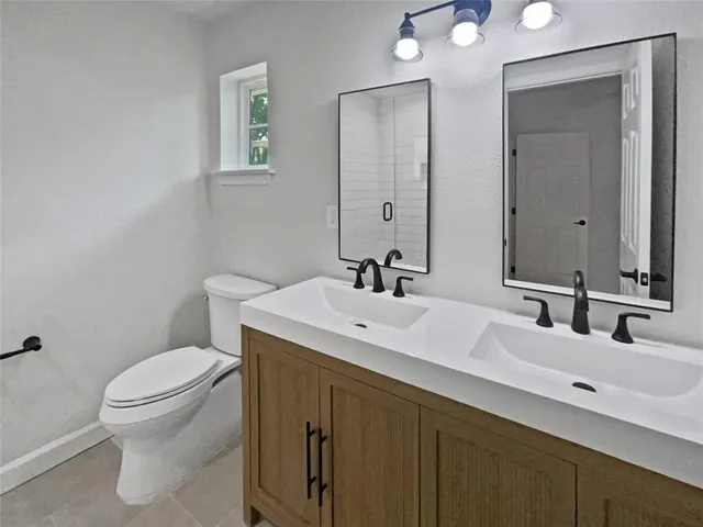 a bathroom with a toilet sink and mirror