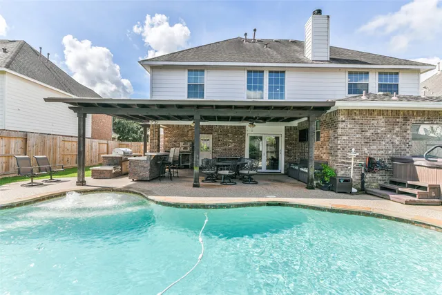 a view of a house with backyard porch and sitting area