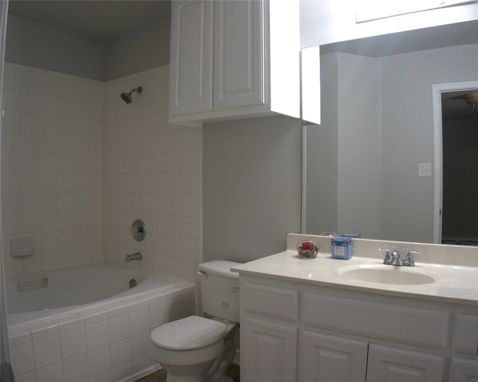 1512 Parkfield Circle Round Rock, TX 78664 - Photo 20 of 26 a bathroom with a sink toilet a bathtub and shower