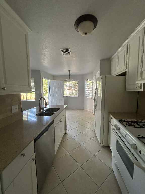 1512 Parkfield Circle Round Rock, TX 78664 - Photo 9 of 26 a kitchen with granite countertop a sink cabinets and stainless steel appliances