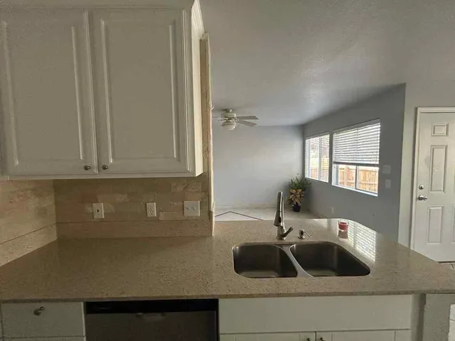a kitchen with a sink and cabinets