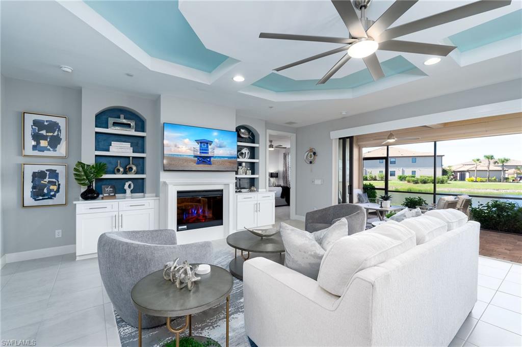 a living room with furniture fireplace and a large window
