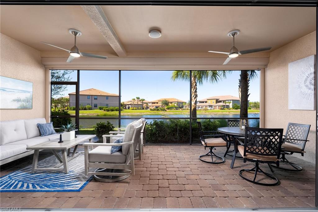 9650 Montelanico Loop, Unit 102 Naples, FL 34119 - Photo 11 of 36 a living room with patio furniture and a floor to ceiling window