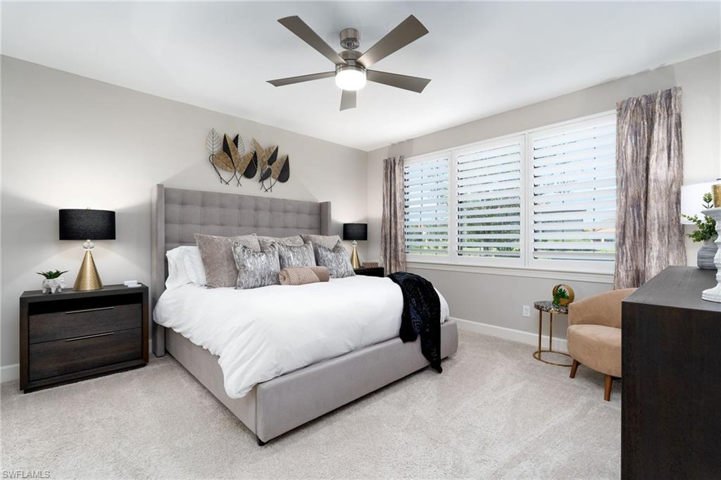 9650 Montelanico Loop, Unit 102 Naples, FL 34119 - Photo 13 of 36 a bedroom with a bed and a couch