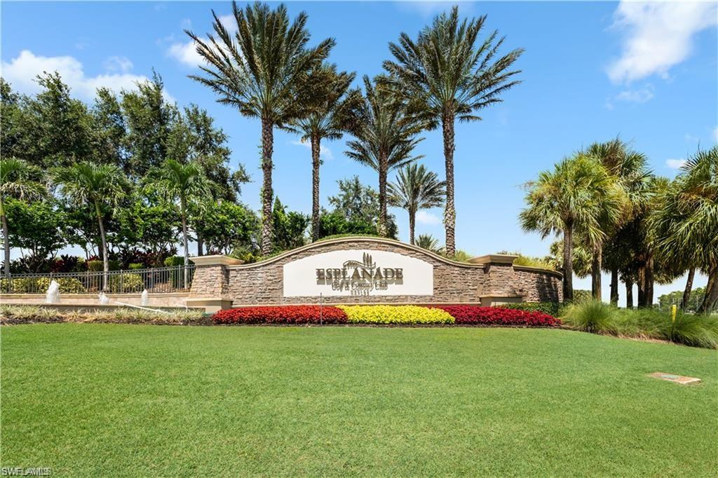 9650 Montelanico Loop, Unit 102 Naples, FL 34119 - Photo 21 of 36 a front view of multi story residential apartment building with yard and green space