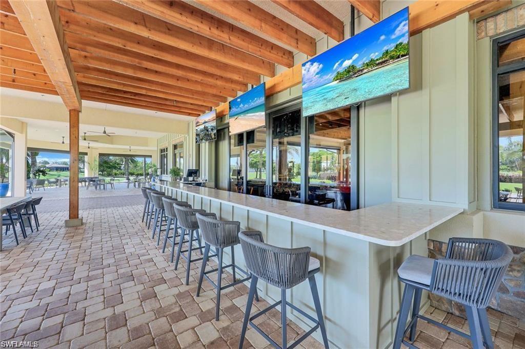 9650 Montelanico Loop, Unit 102 Naples, FL 34119 - Photo 28 of 36 a dining room with furniture and outdoor view