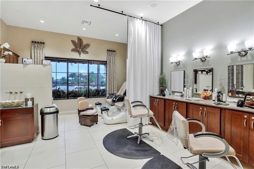9650 Montelanico Loop, Unit 102 Naples, FL 34119 - Photo 34 of 36 a room with lots of furniture and mirrors