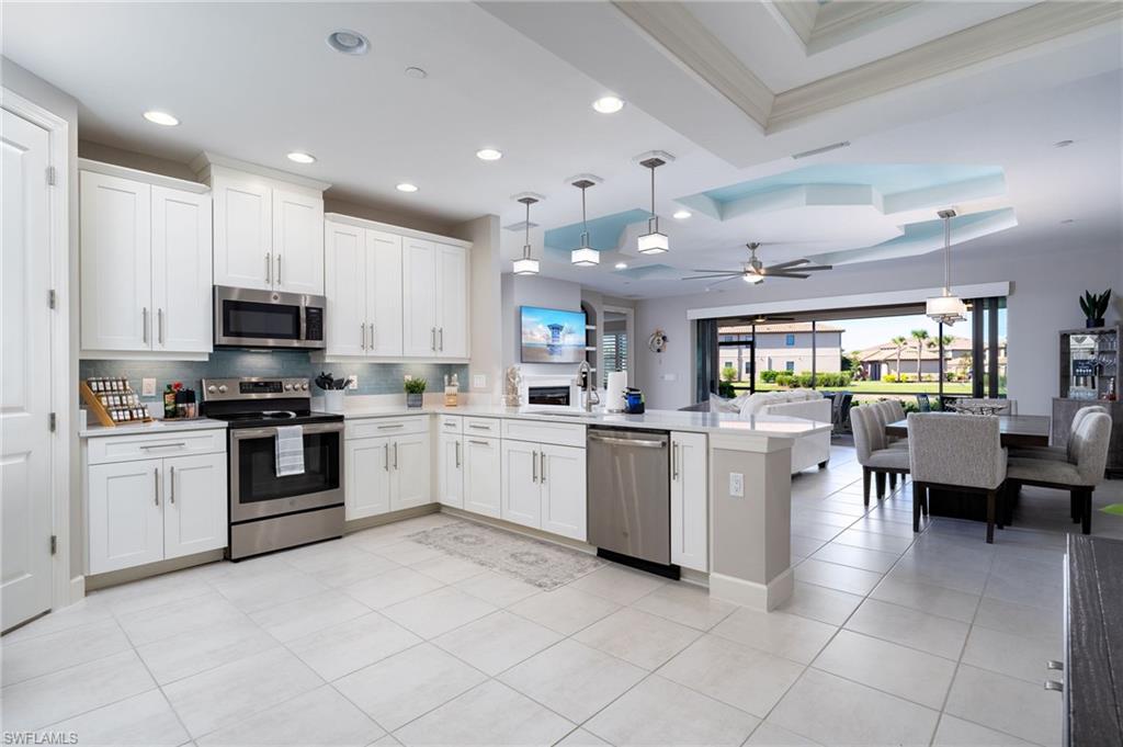 9650 Montelanico Loop, Unit 102 Naples, FL 34119 - Photo 4 of 36 a kitchen with cabinets and chairs
