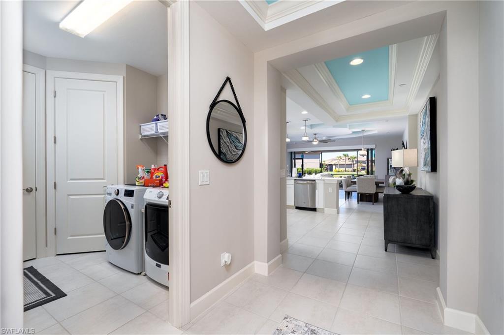 9650 Montelanico Loop, Unit 102 Naples, FL 34119 - Photo 7 of 36 a view of a hallway with a washer and dryer