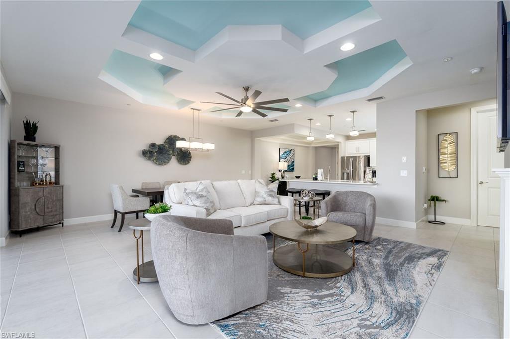 9650 Montelanico Loop, Unit 102 Naples, FL 34119 - Photo 8 of 36 a living room with furniture and a chandelier