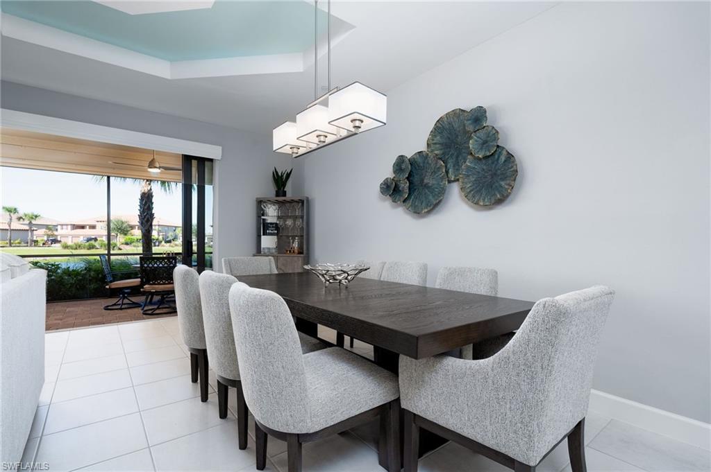 9650 Montelanico Loop, Unit 102 Naples, FL 34119 - Photo 10 of 36 a dining room with furniture and a floor to ceiling window