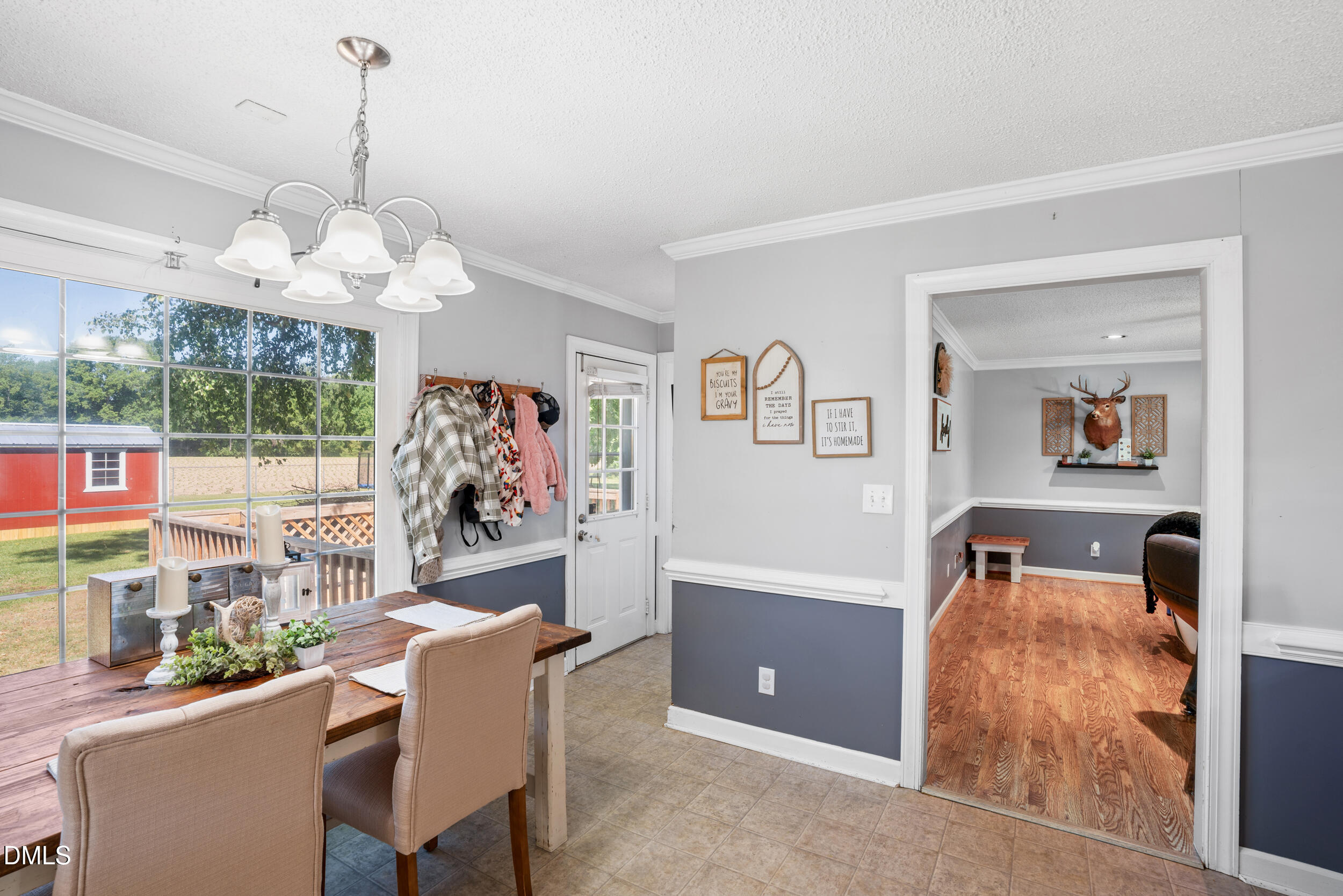 311 Bridgers Road Kenly, NC 27542 - Photo 12 of 46 a dining room with wooden floor and large window